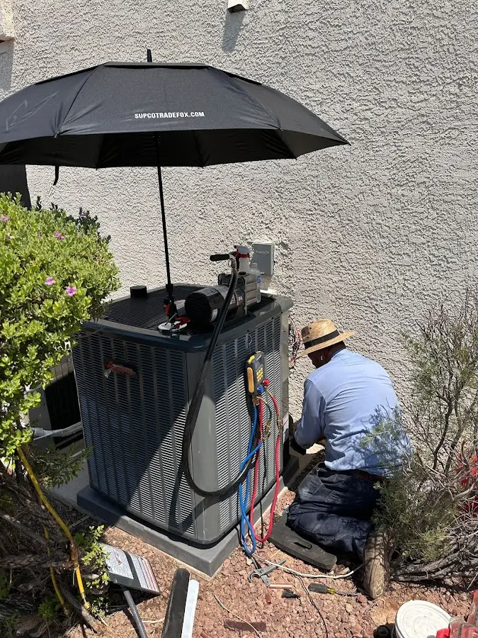 HVAC technician performing outdoor AC maintenance in Irvine